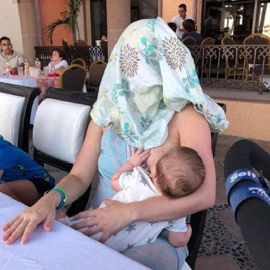 At first glance, it looks like a harmless photo of a woman breastfeeding her baby. Look closer, though, and you’ll see the hidden detail that caused this picture to go viral 😲👇 Full story in the comments … 👇👇